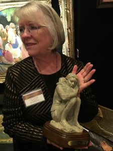 Annette Whitaker Everett holds her sculptural piece, "Rest and Be Thankful," depicting a mother and child, at the Inspirational Art Association's 8th Annual Joseph Smith Memorial Building Christmas Art Showcase.